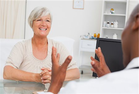 doctor with ethnic patient in office - Happy mature woman got good news from her doctor Stock Photo - Premium Royalty-Free, Code: 6109-06006677