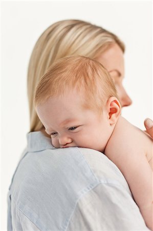 simsearch:6109-06006613,k - Mother holding her little baby against a white background Stock Photo - Premium Royalty-Free, Code: 6109-06006600