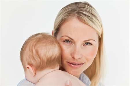 simsearch:6109-06006613,k - Close up of mother holding her baby against a white background Stock Photo - Premium Royalty-Free, Code: 6109-06006601