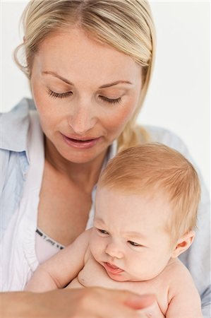 simsearch:6109-06006613,k - Close up of mother with her baby against a white background Stock Photo - Premium Royalty-Free, Code: 6109-06006604