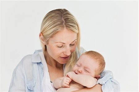 simsearch:6109-06006613,k - Baby sleeping on its mothers arms against a white background Stock Photo - Premium Royalty-Free, Code: 6109-06006608