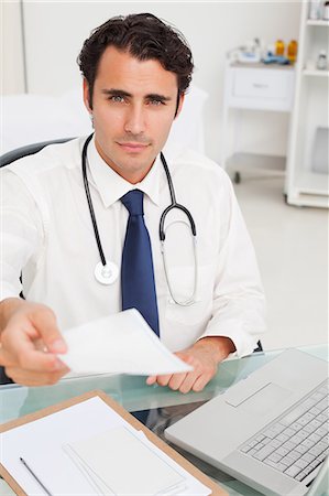 prescription doctor - Young doctor handing over a prescription Stock Photo - Premium Royalty-Free, Code: 6109-06006750