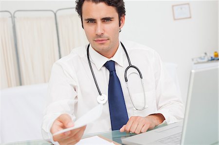 prescription doctor - Serious looking doctor handing over a prescription Stock Photo - Premium Royalty-Free, Code: 6109-06006751