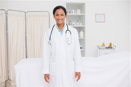 professional medical - Young attractive doctor standing in a hospital room while smiling Stock Photo - Premium Royalty-Free, Code: 6109-06006759