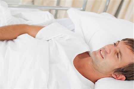 Overhead view of a peaceful patient lying in a private hospital bedroom Stock Photo - Premium Royalty-Free, Code: 6109-06007057