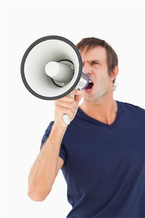 simsearch:6109-06007150,k - Megaphone held by a furious man against a white background Foto de stock - Sin royalties Premium, Código: 6109-06007148