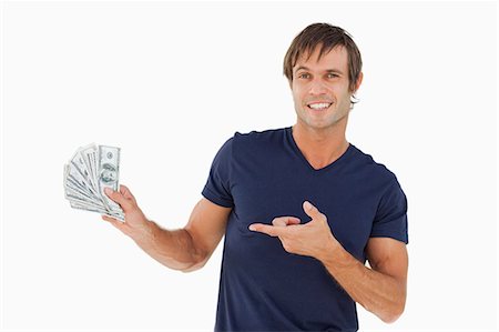 simsearch:6109-06007169,k - Smiling man pointing a fan of bank notes against a white background Foto de stock - Sin royalties Premium, Código: 6109-06007165