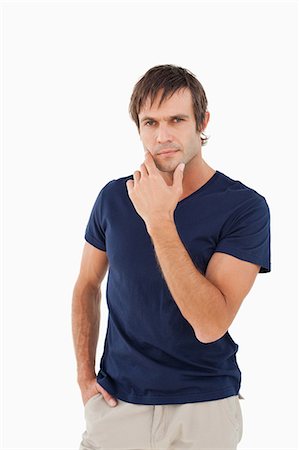 simsearch:6109-06007112,k - Thoughtful man looking straight at the camera while placing his fingers on his chin Foto de stock - Sin royalties Premium, Código: 6109-06007113