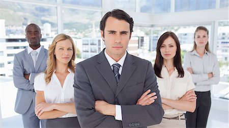 simsearch:6109-06007351,k - Serious businessman standing in front of two women and two men who have their arms crossed Stock Photo - Premium Royalty-Free, Code: 6109-06007201