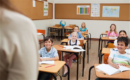 Smiling students listening to their teacher Fotografie stock - Premium Royalty-Free, Codice: 6109-06007443