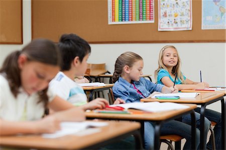 simsearch:6109-06007426,k - Side view of elementary pupils sitting at their desks Stock Photo - Premium Royalty-Free, Code: 6109-06007463