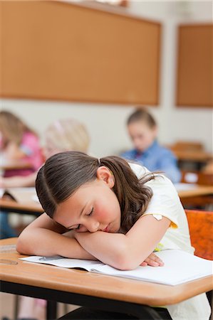 Primary student felt asleep at her desk Stock Photo - Premium Royalty-Free, Code: 6109-06007425