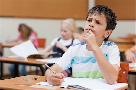 simsearch:6109-06007430,k - Primary student sitting at his desk thinking Stock Photo - Premium Royalty-Free, Code: 6109-06007431