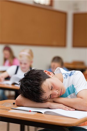 sleeping in a classroom - Elementary student taking a break during class Stock Photo - Premium Royalty-Free, Code: 6109-06007436