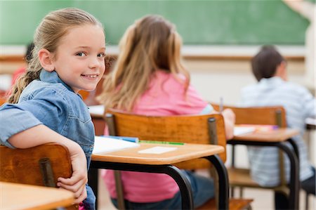 Smiling primary student turned around in class Stock Photo - Premium Royalty-Free, Code: 6109-06007509