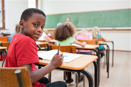 simsearch:6109-06007528,k - Little schoolboy turning around in class Stock Photo - Premium Royalty-Free, Code: 6109-06007516