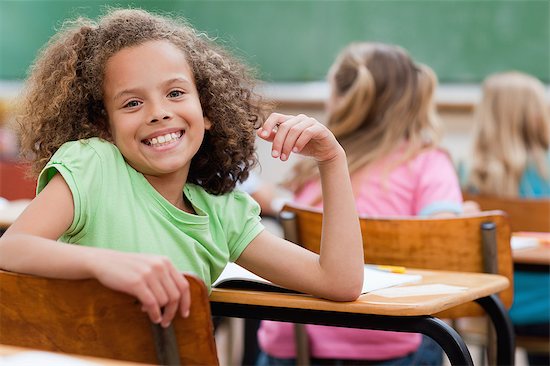 Happy smiling girl turned around during class Stock Photo - Premium Royalty-Free, Image code: 6109-06007519