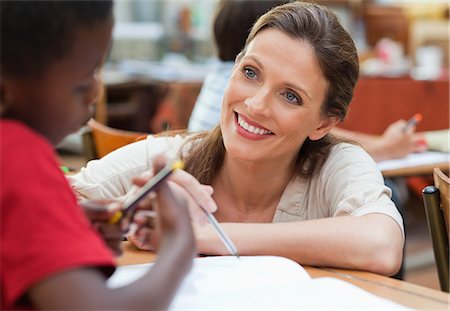 student and teacher - Elementary teacher talking with one of her students Stock Photo - Premium Royalty-Free, Code: 6109-06007534