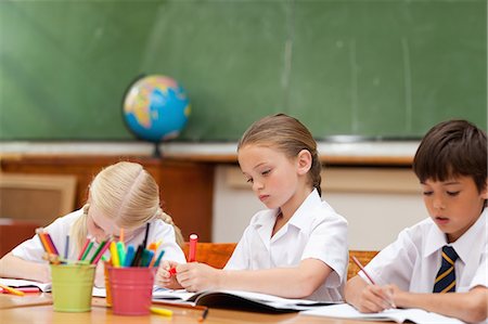 Elementary students painting at desk Stock Photo - Premium Royalty-Free, Code: 6109-06007607