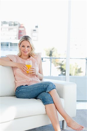 Blondes pieds nus féminins avec un verre de jus de fruits Photographie de stock - Premium Libres de Droits, Code: 6109-06194259