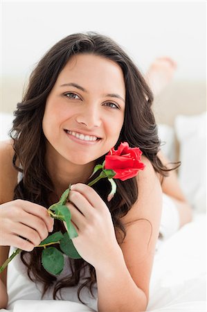 Smiling pretty woman holding a rose Stock Photo - Premium Royalty-Free, Code: 6109-06194387