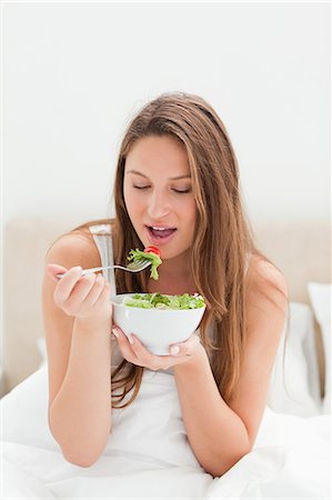 simsearch:6109-06194424,k - Close-up of a pretty woman eating a bowl of salad Stock Photo - Premium Royalty-Free, Code: 6109-06194425