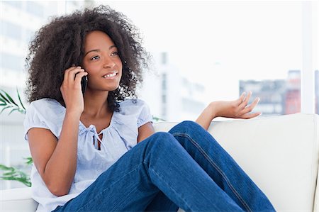 Portrait of a woman with fuzzy hair talking on the phone Stock Photo - Premium Royalty-Free, Code: 6109-06194558