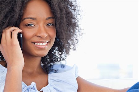 Close-up of a fuzzy hair woman on the phone Stock Photo - Premium Royalty-Free, Code: 6109-06194563