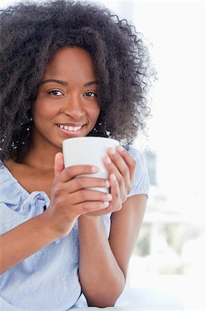 simsearch:6109-06194813,k - Portrait of a woman holding a hot chocolate Stock Photo - Premium Royalty-Free, Code: 6109-06194676