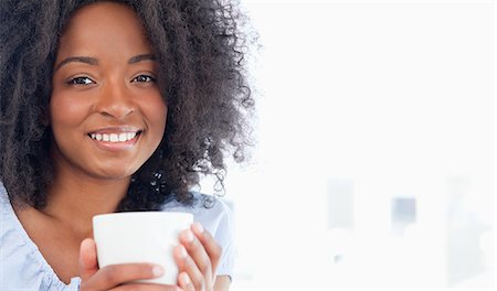 Portrait of a smiling woman holding a hot chocolate Stock Photo - Premium Royalty-Free, Code: 6109-06194678
