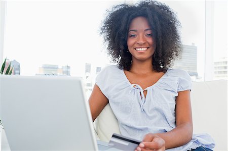 Portrait of a fuzzy hair woman buying online Stock Photo - Premium Royalty-Free, Code: 6109-06194607