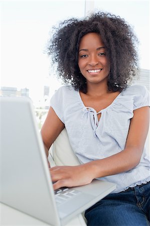 simsearch:6109-06194554,k - Portrait of a fuzzy hair woman tapping on a computer Stock Photo - Premium Royalty-Free, Code: 6109-06194604