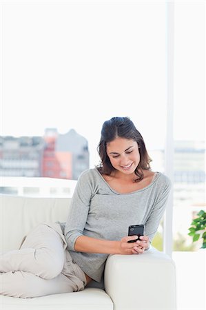 Young woman using a smartphone Stock Photo - Premium Royalty-Free, Code: 6109-06194743