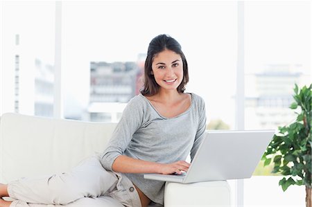 portrait of a beautiful young woman smile - Portrait of a young woman using a computer Stock Photo - Premium Royalty-Free, Code: 6109-06194750