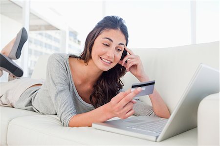 shopping at home - Student looking her credit card number Stock Photo - Premium Royalty-Free, Code: 6109-06194785