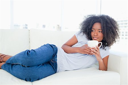 Seductive fuzzy hair woman drinking a tea Stock Photo - Premium Royalty-Free, Code: 6109-06194712