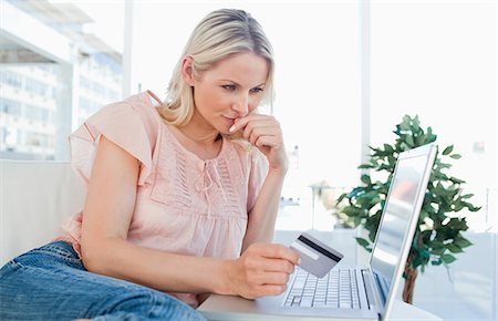 sitting on couch book - Blonde thinking to shop online Foto de stock - Sin royalties Premium, Código: 6109-06195044