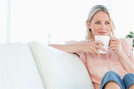 drink milk of woman - Blonde smiling on a divan Stock Photo - Premium Royalty-Free, Code: 6109-06195071