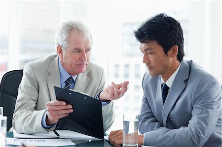 An employee attentively listening to his director Stock Photo - Premium Royalty-Free, Code: 6109-06195238