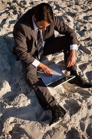 Overhead view of a businessman working on his laptop Stock Photo - Premium Royalty-Free, Code: 6109-06195363