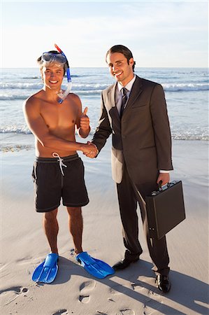 smile of shake hands - Young man in a snorkeling equipment meeting a businessman Stock Photo - Premium Royalty-Free, Code: 6109-06195377