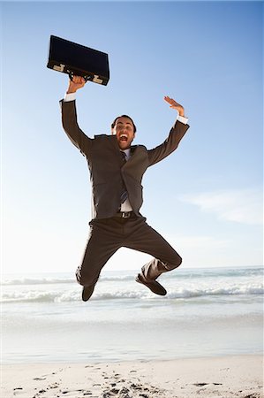 funny person jumping - Young businessman jumping on the beach Stock Photo - Premium Royalty-Free, Code: 6109-06195330