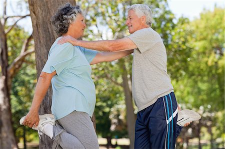 A man and woman are holding each other up while stretching Stock Photo - Premium Royalty-Free, Code: 6109-06195455