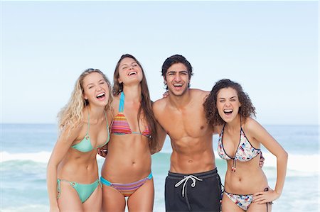 Four friends laughing as they hold each other by the sea Stock Photo - Premium Royalty-Free, Code: 6109-06195475