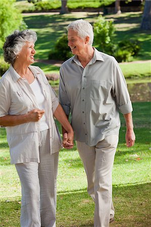 simsearch:6109-06004476,k - couple holding hands and walking in a park Stock Photo - Premium Royalty-Free, Code: 6109-06195419
