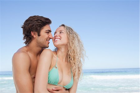 portrait model men picture - Two smiling friends look at each other as they embrace by the sea Stock Photo - Premium Royalty-Free, Code: 6109-06195513