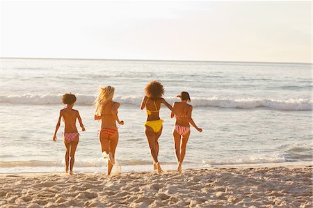 romantic beach sunset - Four friends running together towards the water Stock Photo - Premium Royalty-Free, Code: 6109-06195646