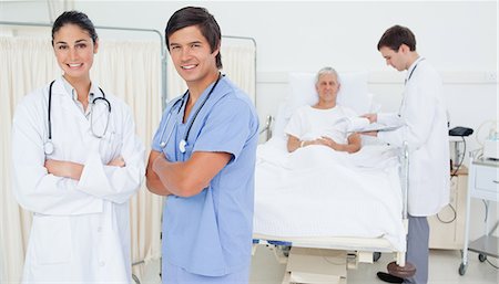 patient and nurse and happy - Smiling doctor and an intern looking ahead while folding their arms Stock Photo - Premium Royalty-Free, Code: 6109-06195692