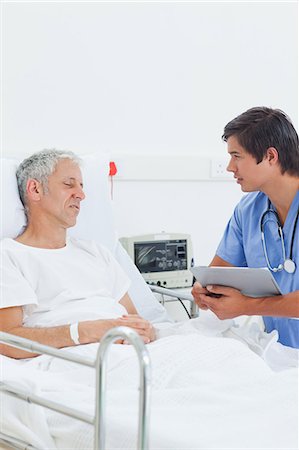 Patient with serious expression being examined by a nurse Stock Photo - Premium Royalty-Free, Code: 6109-06195696