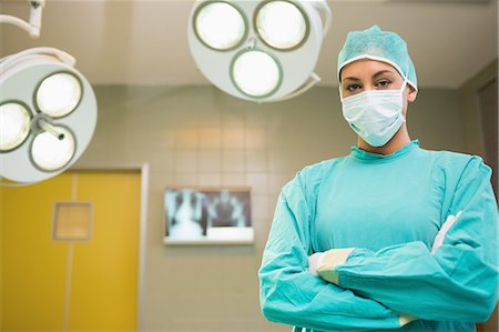 female doctor serious - Nurse with arms crossed wearing surgical clothes Stock Photo - Premium Royalty-Free, Code: 6109-06195767